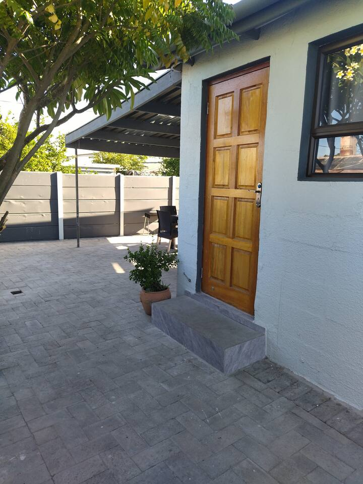 Main entrance 60 on Kosmos guesthouse Bellville South - secure accommodation Cape Town with beautiful wooden door and welcoming porch